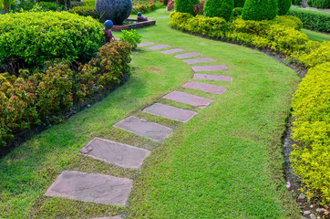 pathway with green grass in garden