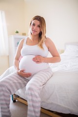 Fototapeta na wymiar Pregnant woman holding her bump