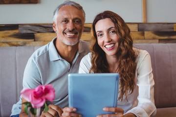 Couple using digital tablet 