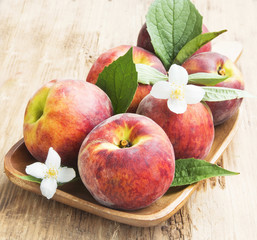 Fresh Peaches with Flowers and Leaves
