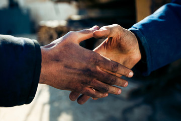 Handshake two workers men at industry close up. - obrazy, fototapety, plakaty