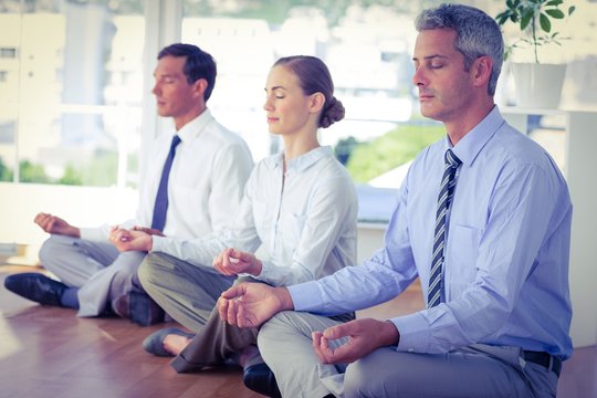 Business People Doing Yoga On Floor 