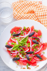 Grapefruit salad with olives, red onion, basil