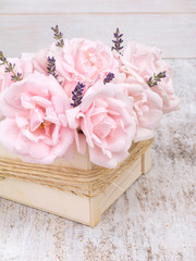 Pale pink roses and lavender bouquet in the wooden box