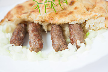 traditional bosnian food cevapi with flat bread and onion