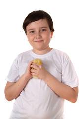 Smiling boy holding a duckling