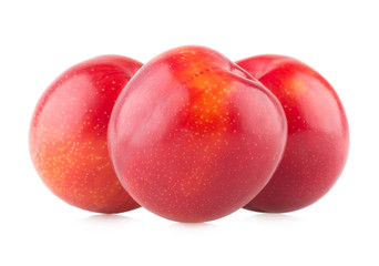 red plums on white background
