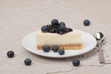 Cheese Cake With Blueberry Jam And Blueberries On White Plate