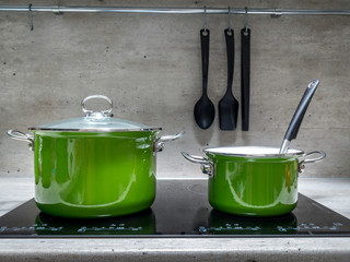 Two stewpots on induction cooker