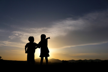 Fototapeta na wymiar Sister and brother at sunset.