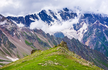 Views of the mountain ranges in the clouds. Caucasus mountains, Bezengi region, Kabardino-Balkaria, Russia