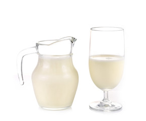 Glass jug pitcher of fresh milk isolated on white background