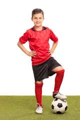 Rolgordijnen Junior soccer player stepping over a ball © Ljupco Smokovski