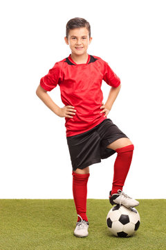 Fototapeta Junior soccer player stepping over a ball