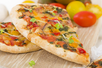 Veggie Pizza - Vegetarian mini pizza on a wooden background.
