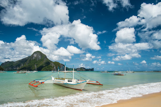 Seaview with the pump boat under cloudy sky in El Nido beach. Palawan, Philippines.