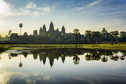 Towers of ancient Angkor Wat reflected in lake at dawn, Cambodia