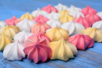 French vanilla meringue cookies on blue background.
