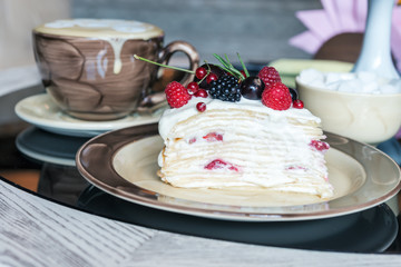  cheese cake with raspberry and mascarpone on a  table with a cup of coffee and sugar
