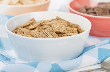 Shreddies - Whole grain wheat cereals in a bue bowl.
