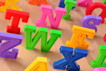 Fototapeta premium Plastic colorful alphabet letters close up