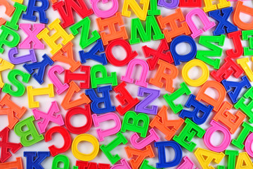 Plastic colorful alphabet letters on a white