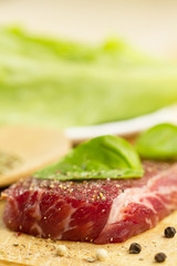 fresh raw pork on cutting Board with spices and herbs.  ?lose up