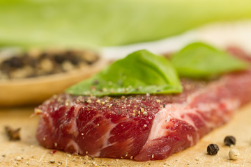 fresh raw pork on cutting Board with spices and herbs.  ?lose up