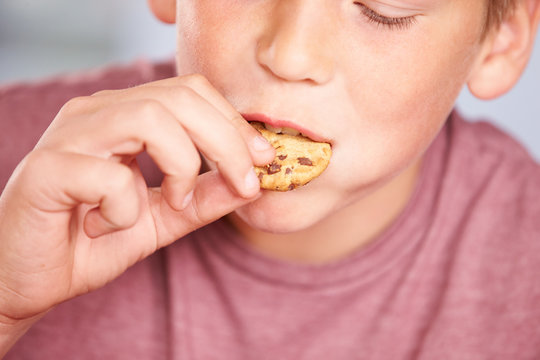 Close Up Of Boy Eating Chocolate Chip Cookie