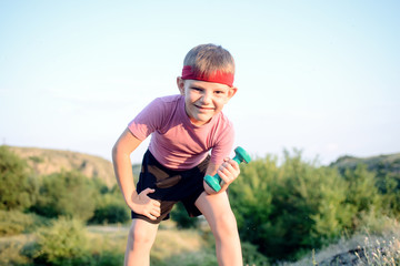 Fototapeta premium Healthy Boy Leans Forward While Lifting Weights