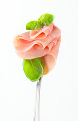Slices of ham on fork