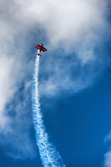 Red biplane aircraft in the blue sky © victorgrow