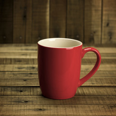 red cup on wood background.