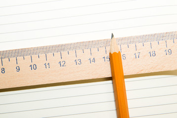 Notepads, pencil and wooden ruler on the old tissue