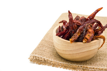 Dried chili in wooden bowl isolated on white background