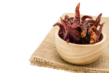 Dried chili in wooden bowl isolated on white background