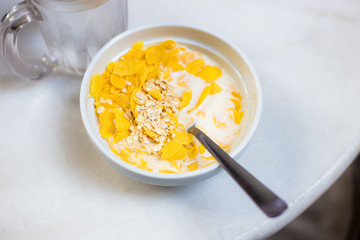 White bowl with breakfast cereal on table