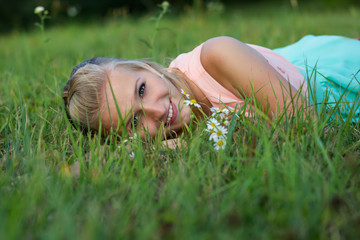 A happy laughing young woman laying on the grass