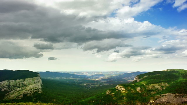 A view from the Ay-Petri plateau (Crimea) towards a valley in timelapse. The rain is coming. FullHD 1080p, brightness stabilized - no flickering.