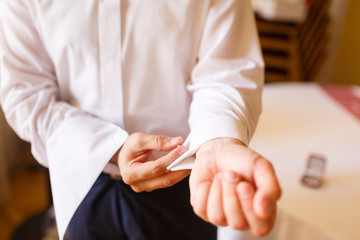 Man puts cufflinks