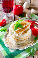 Pastry stuffed with mushrooms and onions on a wooden table