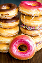 Stack of Glazed Doughnuts with colourful sprinkles, chocolate, i