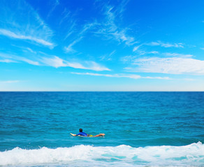 surfer paddling on a surfboard