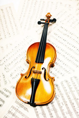 Fototapeta na wymiar Old wood violin lying musical notes