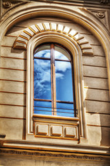 Fototapeta na wymiar sky with clouds reflected in an artistic window