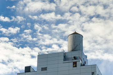 Rooftop Water Tank against Cloudy Sky