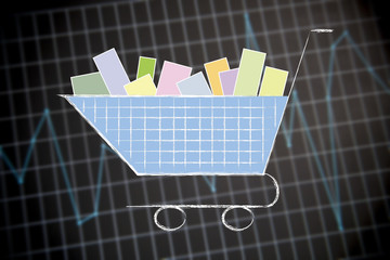 shopping cart on financial stats background
