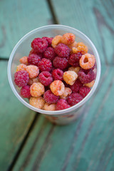 cup raspberries on wood table