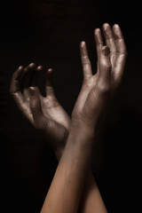 beautiful man's hands in gold paint