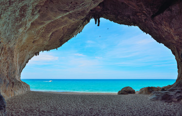 motorboat passing by a big cave in Cala Luna